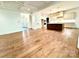Open-concept living room with hardwood floors, coffered ceiling, and seamless flow to the kitchen at 859 Tamary Way # 34, Landis, NC 28088