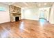 Open living room with a stone fireplace, hardwood floors, coffered ceilings, and ample natural light at 859 Tamary Way # 34, Landis, NC 28088