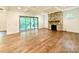 Bright living room features a stone fireplace, wood floors, and sliding glass doors to the outdoor living space at 859 Tamary Way # 34, Landis, NC 28088