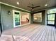Relaxing screened-in porch showcasing wood flooring, ceiling fan, and an open view to the interior at 859 Tamary Way # 34, Landis, NC 28088