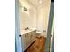 Stylish powder room featuring wood floors, modern vanity, and elegant lighting for a touch of sophistication at 859 Tamary Way # 34, Landis, NC 28088