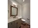 Elegant powder room showcasing a framed mirror, modern vanity, and neutral decor at 859 Tamary Way # 34, Landis, NC 28088