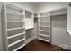 Bright walk-in closet with custom white shelving and rods for maximum storage and organization at 859 Tamary Way # 34, Landis, NC 28088