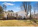 Spacious backyard with a white brick home and a wooden deck at 1628 Shannonhouse Dr, Charlotte, NC 28215