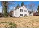 View of the side and rear of a two-story white brick home showing yard at 1628 Shannonhouse Dr, Charlotte, NC 28215