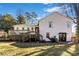Backyard view featuring a well-maintained lawn, a white brick home, and an elevated deck at 1628 Shannonhouse Dr, Charlotte, NC 28215