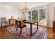 Bright dining room featuring hardwood floors, stylish lighting, and large windows providing natural light at 1628 Shannonhouse Dr, Charlotte, NC 28215