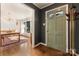 Welcoming foyer featuring a stylish green door and hardwood floors, leading into the dining room at 1628 Shannonhouse Dr, Charlotte, NC 28215