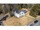 Aerial view of a charming white brick house with black shutters and a well-manicured lawn at 1628 Shannonhouse Dr, Charlotte, NC 28215