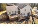 Aerial view of a white brick house with a spacious backyard and an elevated deck at 1628 Shannonhouse Dr, Charlotte, NC 28215