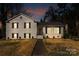 Charming white brick two-story home with black shutters at twilight at 1628 Shannonhouse Dr, Charlotte, NC 28215
