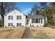 Charming white brick two-story home with black shutters and well-maintained front lawn at 1628 Shannonhouse Dr, Charlotte, NC 28215