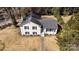 Aerial view of a charming white brick house with black shutters and a well-manicured lawn at 1628 Shannonhouse Dr, Charlotte, NC 28215