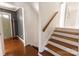 Bright foyer features hardwood floors, stairs, and a gray accent wall at 1628 Shannonhouse Dr, Charlotte, NC 28215
