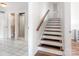 Hallway with staircase and adjacent bathroom featuring tiled floors and glass shower at 1628 Shannonhouse Dr, Charlotte, NC 28215