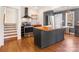 Modern kitchen featuring a dark island with wood countertop and stainless steel appliances at 1628 Shannonhouse Dr, Charlotte, NC 28215