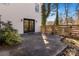 Exterior patio of a white brick home, featuring a wooden fence and greenery at 1628 Shannonhouse Dr, Charlotte, NC 28215
