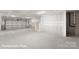 An unfinished basement with concrete floors, walls, and visible staircase at 5860 Pittmon Ln, Kannapolis, NC 28081