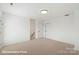 Spacious bedroom with neutral carpet, white walls, and two doors, providing ample space and easy access at 5860 Pittmon Ln, Kannapolis, NC 28081