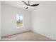 Bright bedroom with a ceiling fan, window, and neutral carpet provides a blank canvas for personalization at 5860 Pittmon Ln, Kannapolis, NC 28081