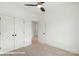 Bedroom featuring neutral carpet, ceiling fan, and white doors and trim, creating a serene and comfortable space at 5860 Pittmon Ln, Kannapolis, NC 28081