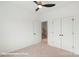 Bedroom featuring neutral carpet, ceiling fan, and white doors and trim, creating a serene and comfortable space at 5860 Pittmon Ln, Kannapolis, NC 28081