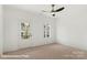 Bright bedroom featuring a ceiling fan, and door and window providing natural light at 5860 Pittmon Ln, Kannapolis, NC 28081