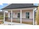 Quaint exterior with a cozy porch and black railings at 5860 Pittmon Ln, Kannapolis, NC 28081