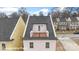 An exterior view of a home showing the rooftop deck with railing and door at 5860 Pittmon Ln, Kannapolis, NC 28081