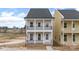 Charming two-story home featuring double porches with black railings and a light pink exterior at 5860 Pittmon Ln, Kannapolis, NC 28081