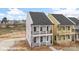 Charming two-story home featuring double porches with black railings and a light pink exterior at 5860 Pittmon Ln, Kannapolis, NC 28081