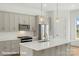 Modern kitchen boasts stainless steel appliances, custom cabinetry, and a large center island at 5860 Pittmon Ln, Kannapolis, NC 28081