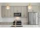 Close-up of a modern kitchen with stainless steel appliances, custom cabinets, and stylish backsplash at 5860 Pittmon Ln, Kannapolis, NC 28081