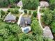 Beautiful aerial view showcases a home with a pool surrounded by lush greenery and neighboring houses in a serene setting at 7582 Cottonwood Dr # 39, Denver, NC 28037