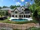 Stunning backyard features a large swimming pool, a hot tub, a patio, and a lush green lawn, perfect for outdoor living at 7582 Cottonwood Dr # 39, Denver, NC 28037