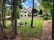 Expansive backyard featuring a cozy fire pit area, perfect for outdoor gatherings and enjoying the serene woodland setting at 7582 Cottonwood Dr # 39, Denver, NC 28037