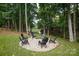 Picturesque backyard fire pit encircled by Adirondack chairs, providing a cozy and inviting space for outdoor relaxation and socializing at 7582 Cottonwood Dr # 39, Denver, NC 28037