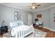 Cozy bedroom features a ceiling fan, a white bed frame, and a comfortable workspace with a desk and computer at 7582 Cottonwood Dr # 39, Denver, NC 28037