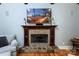 Detailed shot of the living room fireplace with stone accents and a decorative mantle at 7582 Cottonwood Dr # 39, Denver, NC 28037