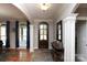 Welcoming foyer with hardwood floors, elegant columns, and a stylish entry door at 7582 Cottonwood Dr # 39, Denver, NC 28037