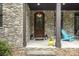Inviting front entrance featuring a stone facade and an arched wood door at 7582 Cottonwood Dr # 39, Denver, NC 28037