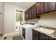 Well-lit laundry room featuring a washer, dryer, and storage cabinets at 7582 Cottonwood Dr # 39, Denver, NC 28037