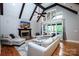 Spacious living room with a vaulted ceiling, wood beams, a stone fireplace, and large windows at 7582 Cottonwood Dr # 39, Denver, NC 28037