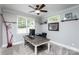 Bright office space featuring a ceiling fan, natural light, and a spacious desk at 7582 Cottonwood Dr # 39, Denver, NC 28037
