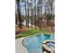 Inviting pool and fire pit with natural surroundings creating a peaceful outdoor oasis for relaxation and entertainment at 7582 Cottonwood Dr # 39, Denver, NC 28037