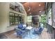 A covered porch with wooden floors, a fireplace, and a comfortable seating area at 7582 Cottonwood Dr # 39, Denver, NC 28037