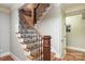 Beautiful staircase featuring wood steps, black iron spindles and wooden banister at 7582 Cottonwood Dr # 39, Denver, NC 28037