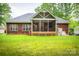 Spacious backyard showcases a large screened porch and lush green lawn at 2518 Wellesbourne Ln, Sherrills Ford, NC 28673