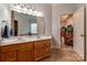 Bathroom with double sinks and a view into the bedroom with a tray ceiling and comfortable seating at 2518 Wellesbourne Ln, Sherrills Ford, NC 28673