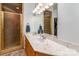 Bathroom featuring double sinks with an elegant marble countertop and a tiled shower at 2518 Wellesbourne Ln, Sherrills Ford, NC 28673